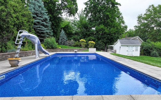 25 Mckinley St, Pearl River, NY 10965 - outdoor pool with a water slide, an outdoor structure, and a yard