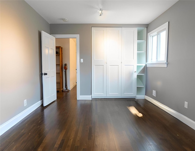 16107 90th St, Howard Beach, NY 11414 - unfurnished bedroom with dark wood-style flooring