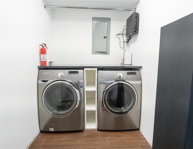 16107 90th St, Howard Beach, NY 11414 - laundry room featuring separate washer and dryer, electric panel, and wood tiled floors