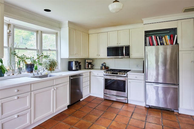 54 Davis Ln, Grahamsville, NY 12740 - kitchen with stainless steel appliances, light countertops, white cabinets, ornamental molding, and dark tile patterned flooring