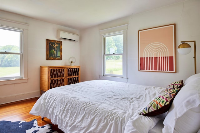 54 Davis Ln, Grahamsville, NY 12740 - bedroom featuring a wall mounted air conditioner and wood finished floors