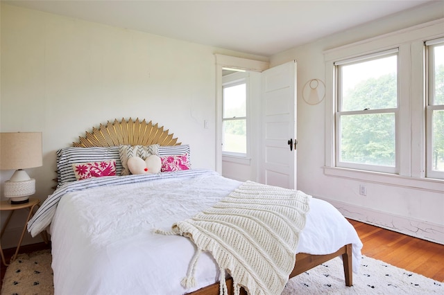 54 Davis Ln, Grahamsville, NY 12740 - bedroom featuring multiple windows and wood finished floors