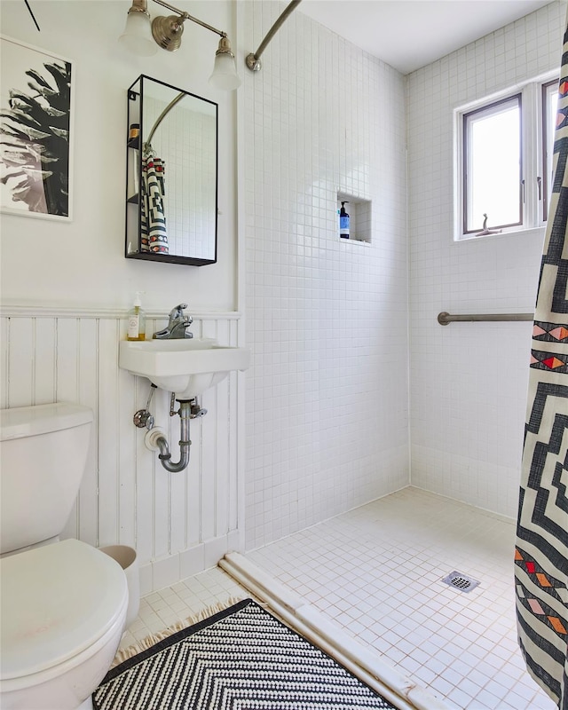 54 Davis Ln, Grahamsville, NY 12740 - bathroom featuring tiled shower, tile patterned flooring, and wainscoting
