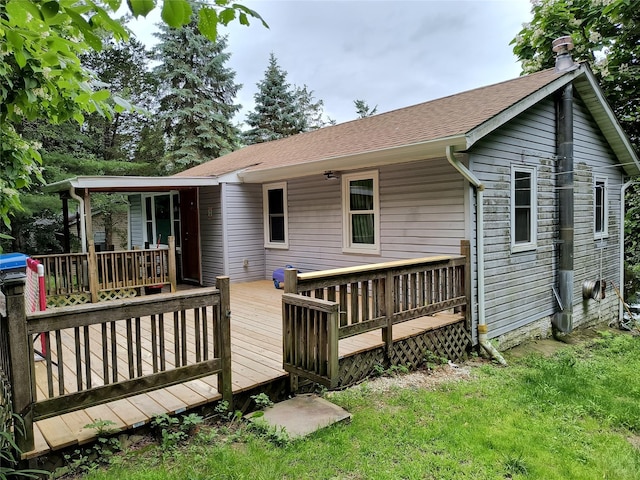 1 Whippoorwill Trl, Monroe, NY 10950 - back of property featuring a yard, a shingled roof, a deck, and a chimney