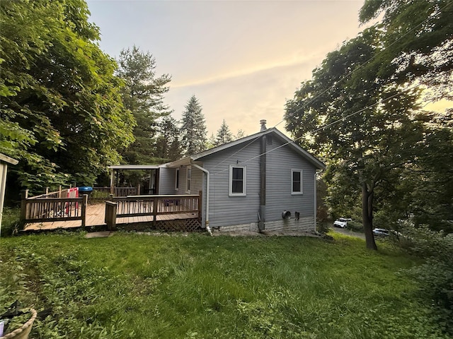 1 Whippoorwill Trl, Monroe, NY 10950 - back of house at dusk with a wooden deck and a lawn