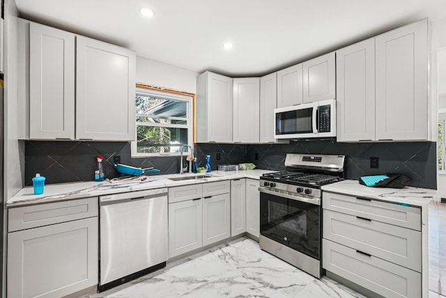 1 Whippoorwill Trl, Monroe, NY 10950 - kitchen featuring appliances with stainless steel finishes, recessed lighting, light stone countertops, light marble finish floors, and decorative backsplash