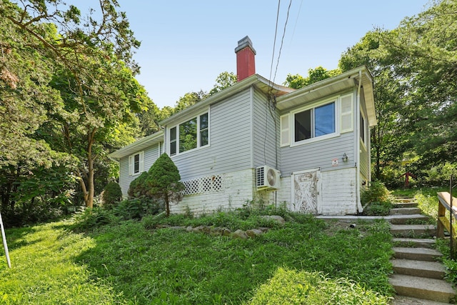 1 Whippoorwill Trl, Monroe, NY 10950 - rear view of property featuring a chimney and stairs