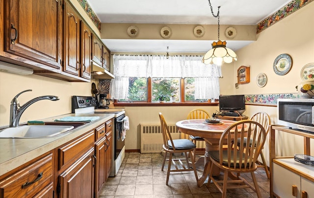 15 Lane Ave, Plainview, NY 11803 - kitchen featuring radiator heating unit, white range with electric stovetop, light countertops, stainless steel microwave, and under cabinet range hood