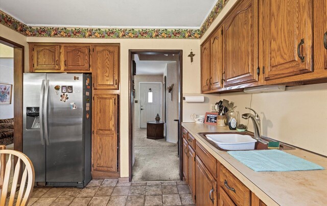 15 Lane Ave, Plainview, NY 11803 - kitchen featuring stainless steel fridge with ice dispenser, light countertops, brown cabinetry, and light stone finish floors