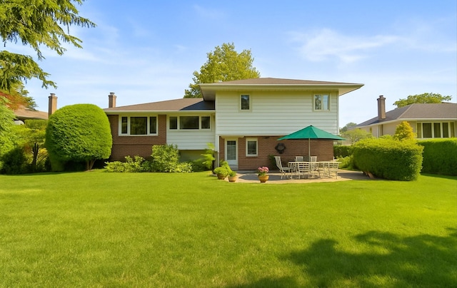 15 Lane Ave, Plainview, NY 11803 - back of house with brick siding, a patio area, and a lawn