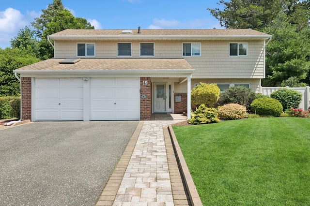 19 Evelyn Rd, Plainview, NY 11803 - view of front facade featuring a front lawn, asphalt driveway, a shingled roof, and brick siding