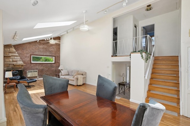 19 Evelyn Rd, Plainview, NY 11803 - dining space featuring track lighting, a skylight, wood finished floors, vaulted ceiling, and stairs