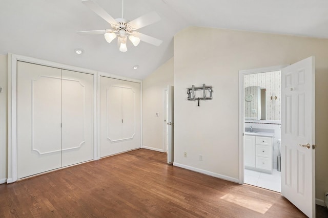 19 Evelyn Rd, Plainview, NY 11803 - unfurnished bedroom featuring wood finished floors, vaulted ceiling, two closets, ensuite bathroom, and a ceiling fan