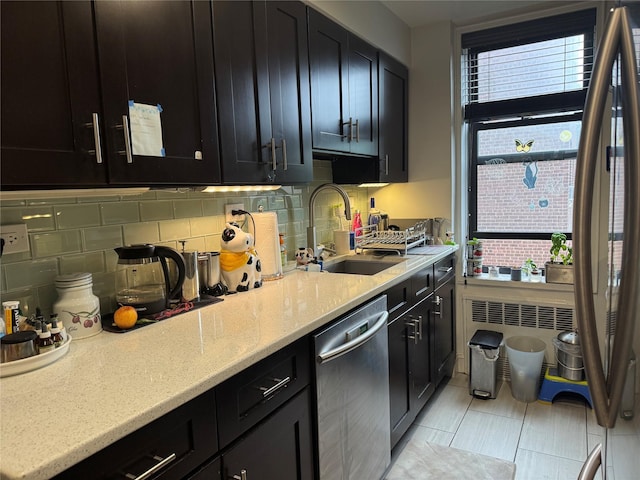 33-27 91st St Unit 5F, Jackson Heights, NY 11372 - kitchen with stainless steel dishwasher, dark cabinets, decorative backsplash, light stone counters, and light tile patterned floors