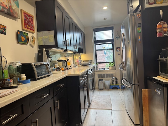 33-27 91st St Unit 5F, Jackson Heights, NY 11372 - kitchen with recessed lighting, dark cabinetry, freestanding refrigerator, fridge, and light tile patterned flooring