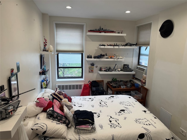 33-27 91st St Unit 5F, Jackson Heights, NY 11372 - bedroom featuring radiator heating unit, multiple windows, cooling unit, and recessed lighting