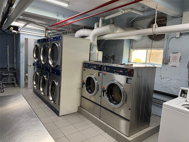 33-27 91st St Unit 5F, Jackson Heights, NY 11372 - community laundry featuring independent washer and dryer, estacked washer and dryer, and light tile patterned floors