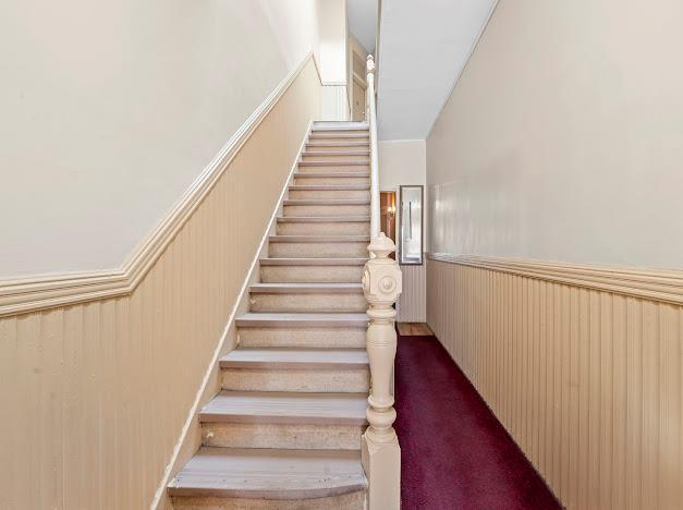 6259 60th St, Ridgewood, NY 11385 - stairway with wainscoting and carpet flooring