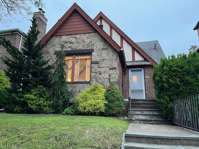 32-15 149th St, Flushing, NY 11354 - english style home with stone siding, a front yard, and brick siding