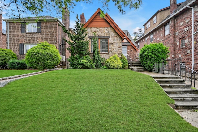 32-15 149th St, Flushing, NY 11354 - view of front of property featuring stairs, stone siding, a front yard, and a chimney