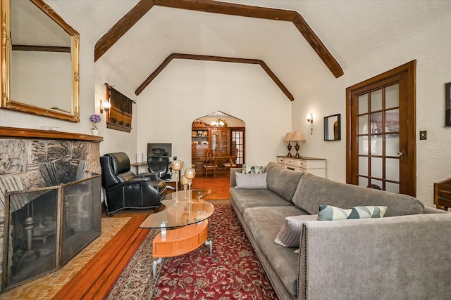 32-15 149th St, Flushing, NY 11354 - living room featuring wood finished floors, arched walkways, a fireplace, high vaulted ceiling, and beamed ceiling