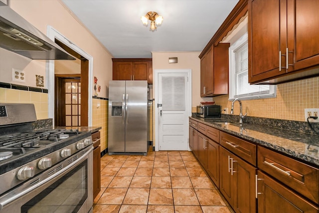 32-15 149th St, Flushing, NY 11354 - kitchen with appliances with stainless steel finishes, extractor fan, dark stone countertops, and decorative backsplash