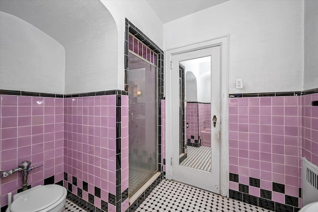 32-15 149th St, Flushing, NY 11354 - bathroom featuring tile walls, radiator, a shower stall, and wainscoting