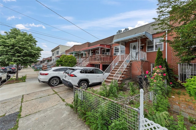 1157 E 102nd St, Brooklyn, NY 11236 - view of front of property featuring brick siding, mansard roof, and roof with shingles