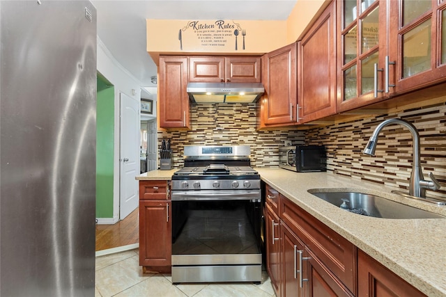 1157 E 102nd St, Brooklyn, NY 11236 - kitchen featuring appliances with stainless steel finishes, under cabinet range hood, light tile patterned floors, decorative backsplash, and light stone countertops