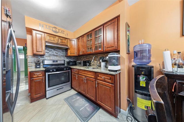 1157 E 102nd St, Brooklyn, NY 11236 - kitchen with appliances with stainless steel finishes, under cabinet range hood, decorative backsplash, and light stone counters