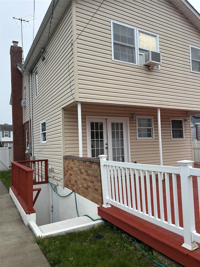 92 Norfeld Blvd, Elmont, NY 11003 - back of property featuring brick siding, a wooden deck, and cooling unit