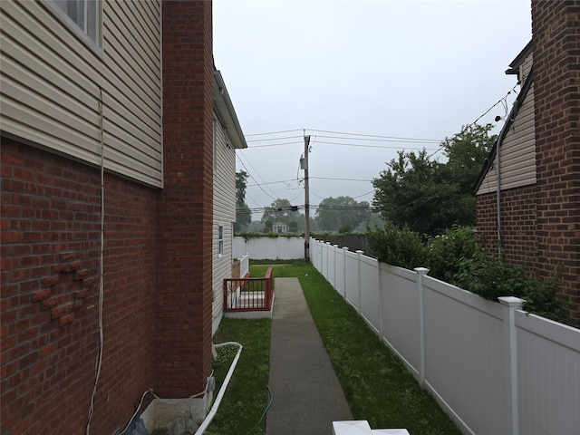 92 Norfeld Blvd, Elmont, NY 11003 - view of home's exterior with a fenced backyard and brick siding