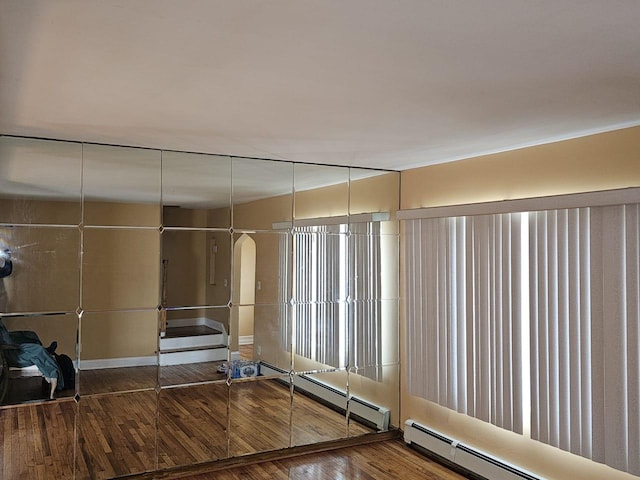 92 Norfeld Blvd, Elmont, NY 11003 - unfurnished room featuring baseboard heating and wood finished floors