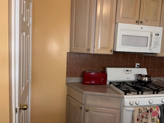 92 Norfeld Blvd, Elmont, NY 11003 - kitchen with white appliances and decorative backsplash