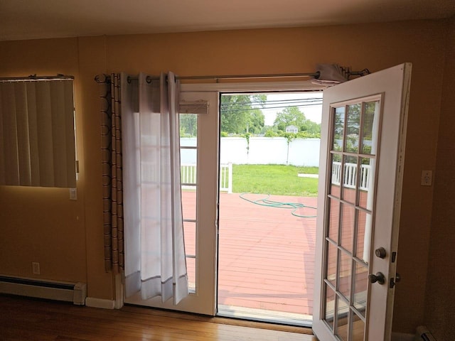 92 Norfeld Blvd, Elmont, NY 11003 - doorway to outside featuring a baseboard heating unit and wood finished floors