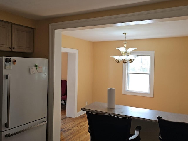 92 Norfeld Blvd, Elmont, NY 11003 - dining area with light wood-type flooring, a chandelier, and an office area