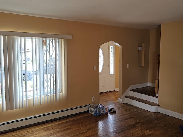 92 Norfeld Blvd, Elmont, NY 11003 - foyer entrance featuring a baseboard radiator, plenty of natural light, arched walkways, and wood finished floors