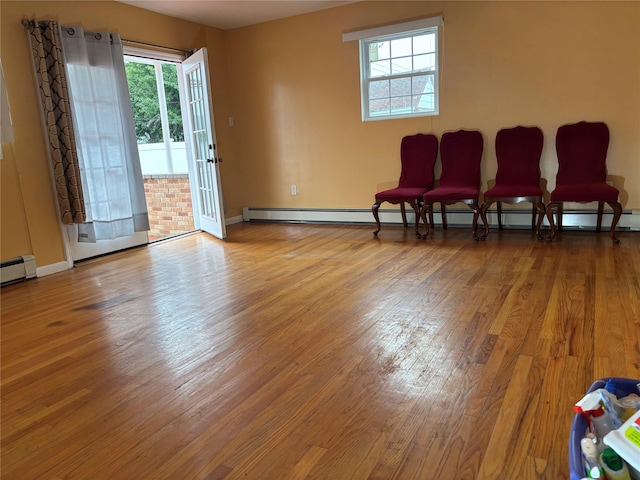 92 Norfeld Blvd, Elmont, NY 11003 - sitting room with wood finished floors, healthy amount of natural light, and a baseboard radiator