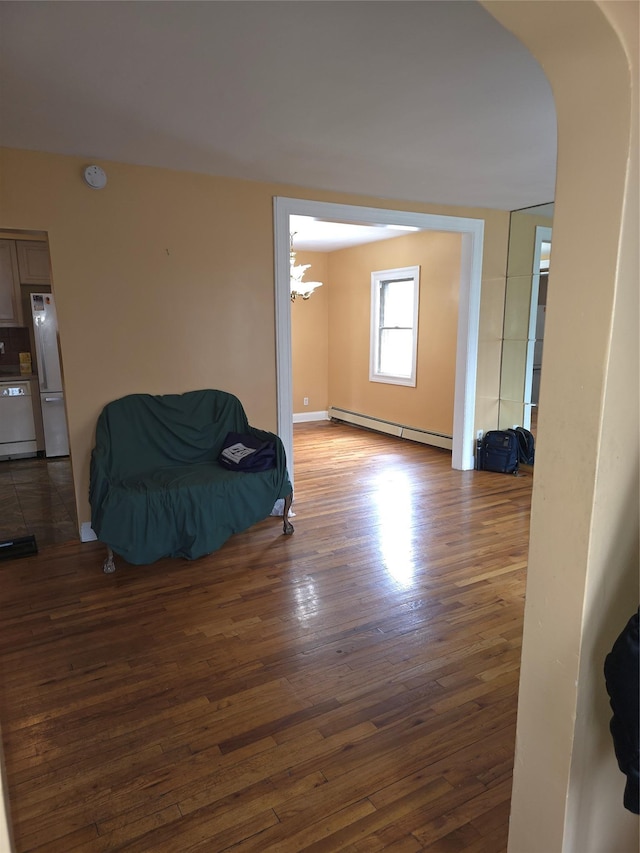 92 Norfeld Blvd, Elmont, NY 11003 - sitting room featuring a baseboard heating unit, hardwood / wood-style flooring, arched walkways, and a chandelier