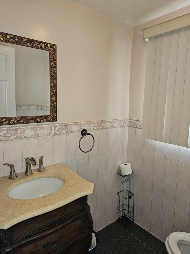 92 Norfeld Blvd, Elmont, NY 11003 - bathroom featuring tile walls, vanity, and a wainscoted wall