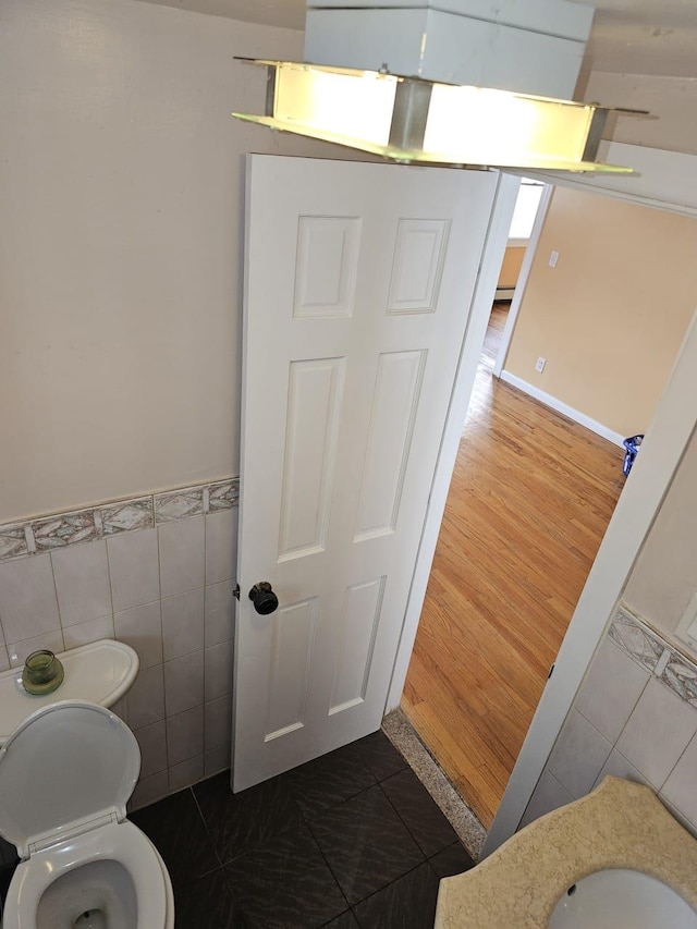 92 Norfeld Blvd, Elmont, NY 11003 - bathroom featuring tile walls and a wainscoted wall