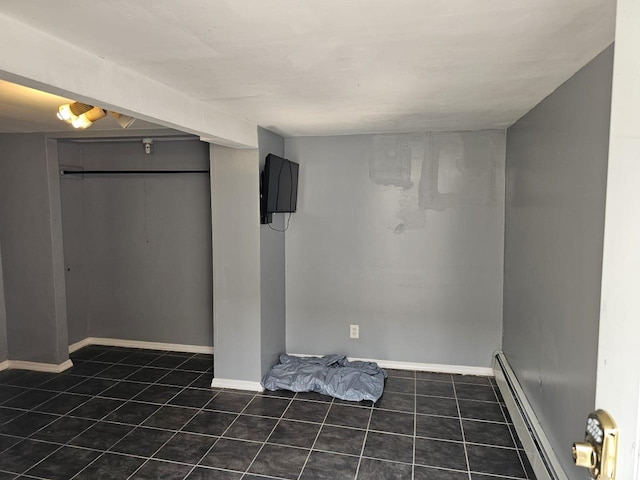 92 Norfeld Blvd, Elmont, NY 11003 - finished basement featuring a baseboard heating unit and tile patterned flooring