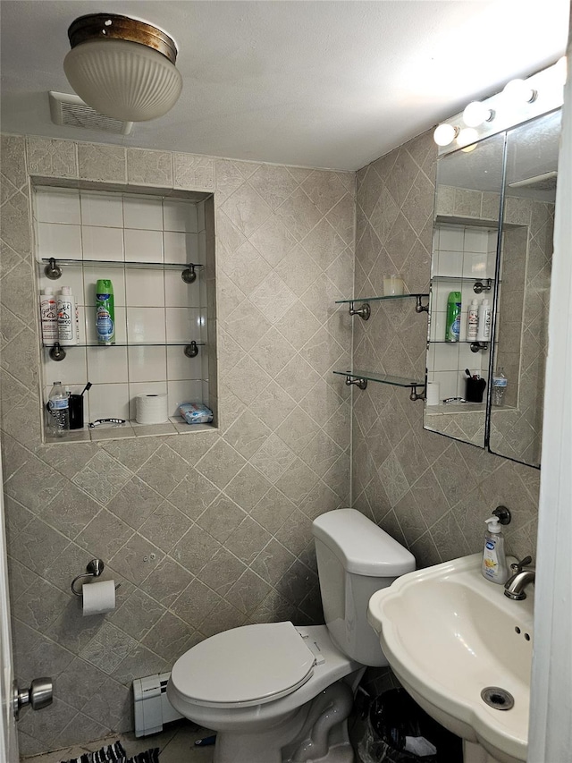 92 Norfeld Blvd, Elmont, NY 11003 - half bath featuring tile walls and baseboard heating