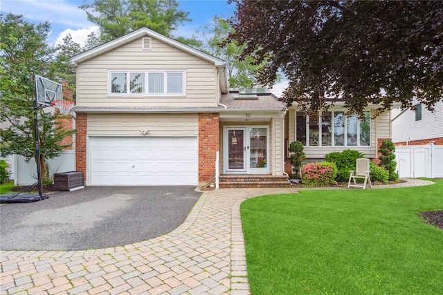11 Robin Ln, Plainview, NY 11803 - view of front facade featuring driveway, a garage, brick siding, and french doors