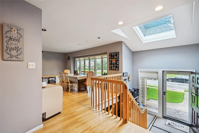 11 Robin Ln, Plainview, NY 11803 - corridor with light wood-style floors, a skylight, recessed lighting, and an upstairs landing