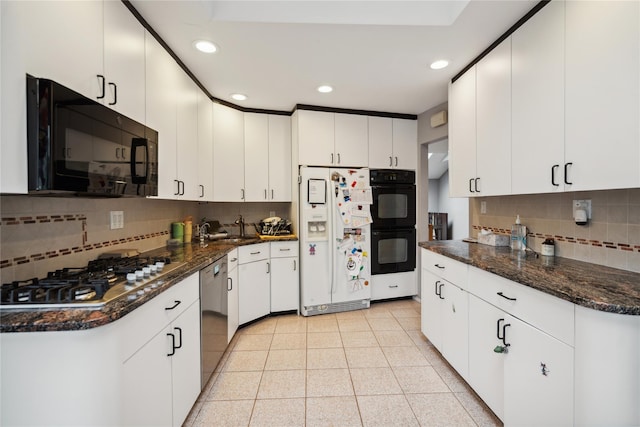 11 Robin Ln, Plainview, NY 11803 - kitchen featuring black appliances, tasteful backsplash, recessed lighting, white cabinetry, and dark stone counters