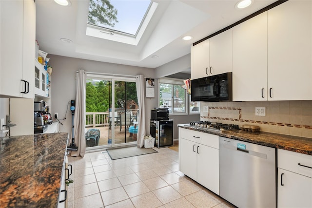 11 Robin Ln, Plainview, NY 11803 - kitchen featuring appliances with stainless steel finishes, a skylight, decorative backsplash, white cabinetry, and recessed lighting