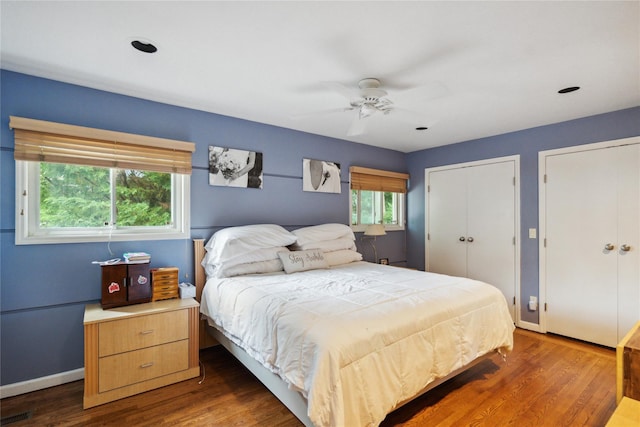 11 Robin Ln, Plainview, NY 11803 - bedroom with multiple closets, dark wood-style floors, and ceiling fan
