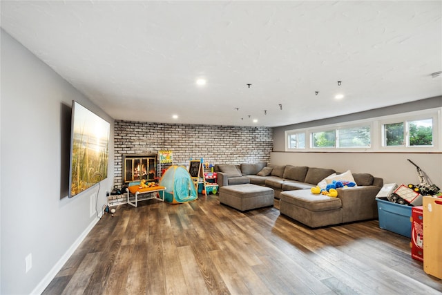 11 Robin Ln, Plainview, NY 11803 - living area featuring brick wall, wood finished floors, a fireplace, and recessed lighting