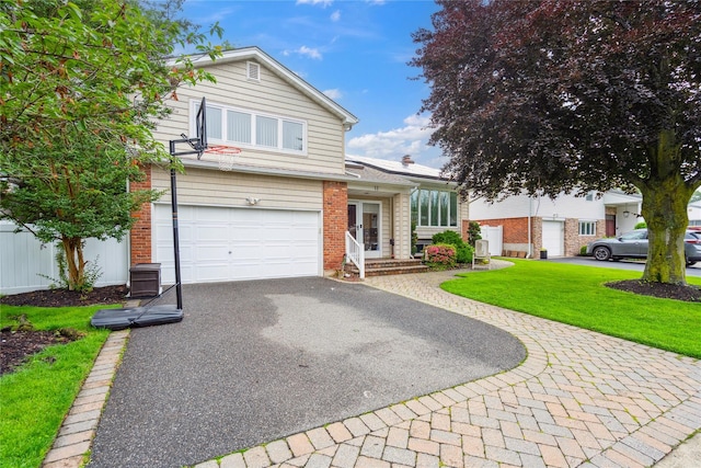 11 Robin Ln, Plainview, NY 11803 - view of front facade featuring driveway, an attached garage, a front lawn, and brick siding